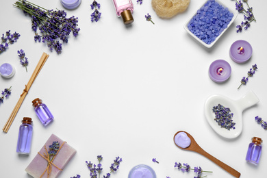 Cosmetic products and lavender flowers on white background, flat lay