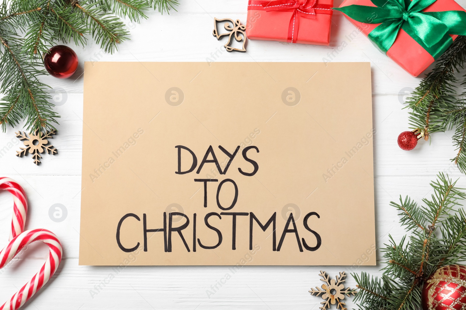 Photo of Flat lay composition of card with words Days To Christmas and space for text on white wooden table. Holiday countdown