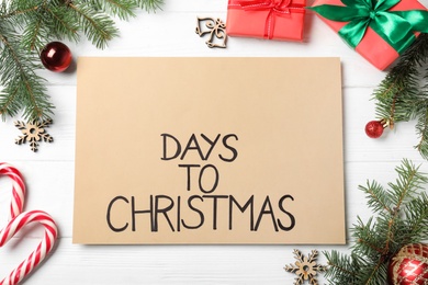 Photo of Flat lay composition of card with words Days To Christmas and space for text on white wooden table. Holiday countdown