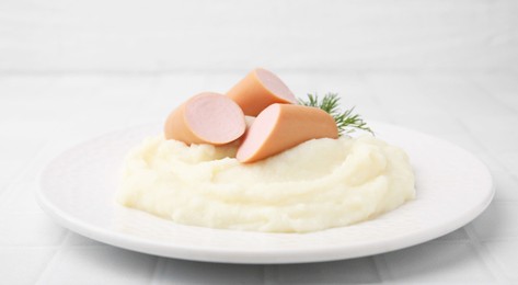 Photo of Delicious boiled sausages, mashed potato and dill on white table, closeup