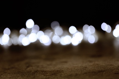 Blurred view of festive lights on dark background. Bokeh effect