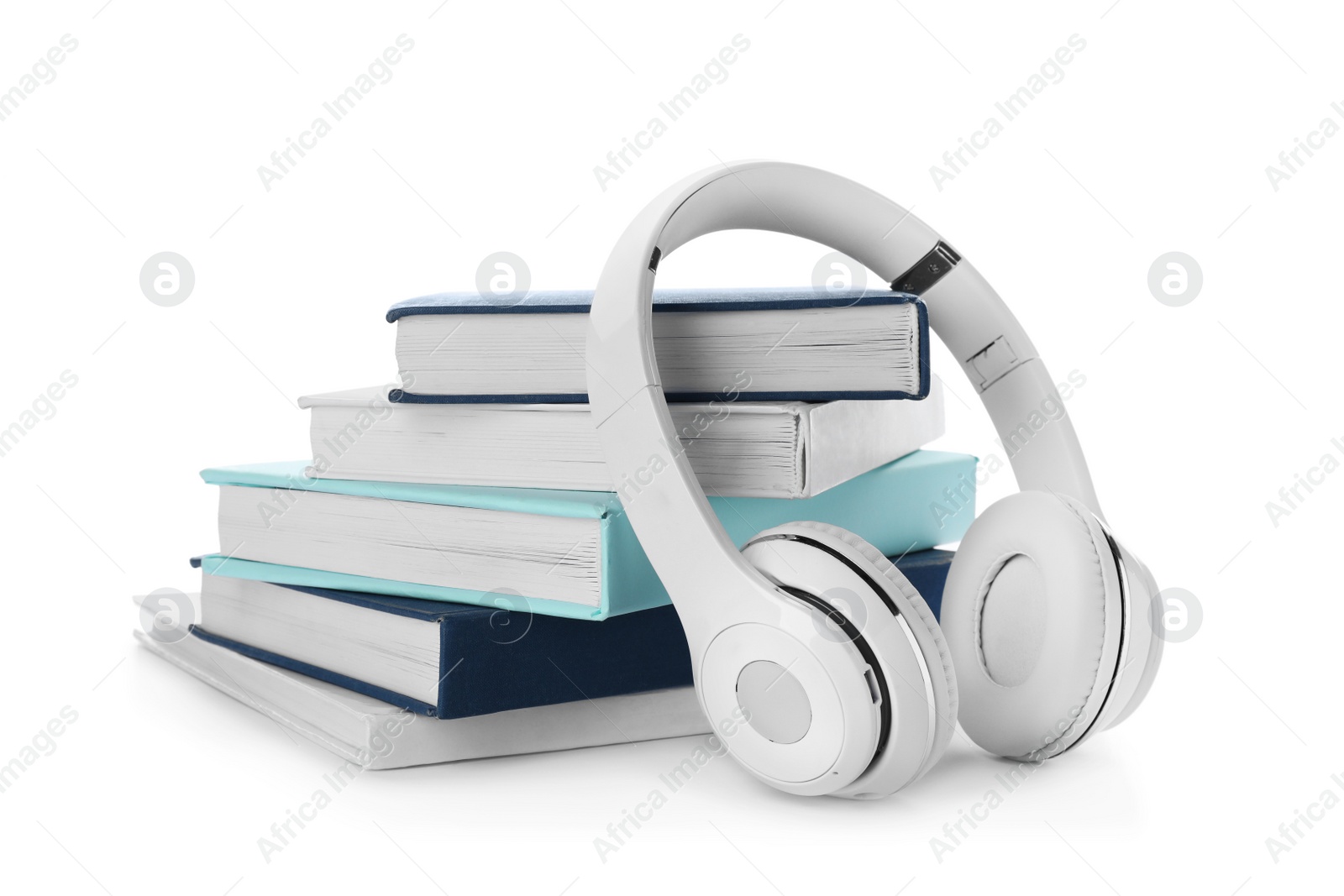 Photo of Modern headphones with hardcover books on white background