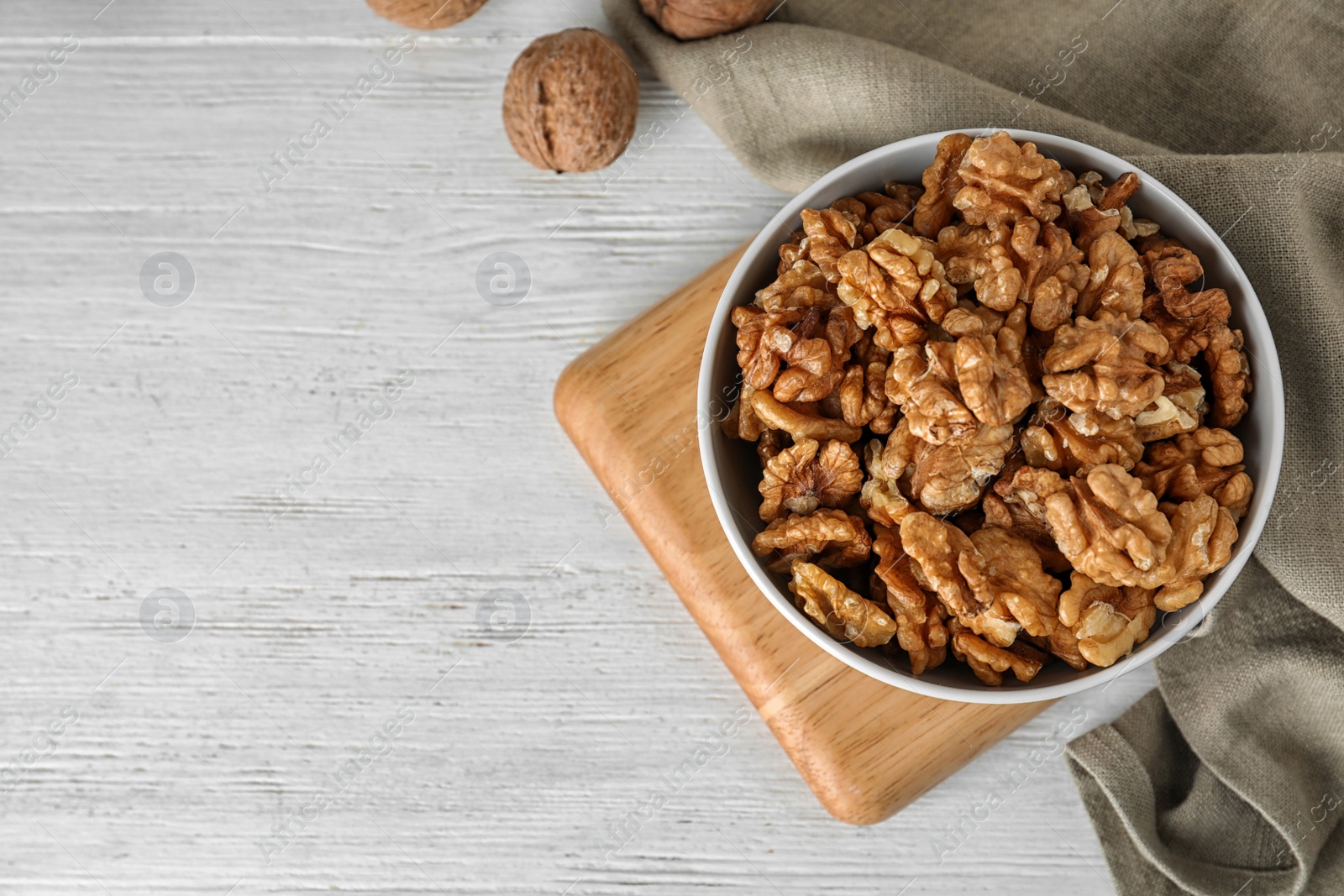 Photo of Flat lay composition with walnuts and space for text on wooden background