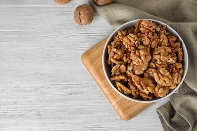 Flat lay composition with walnuts and space for text on wooden background