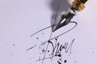 Photo of Signing on sheet of paper with fountain pen, closeup