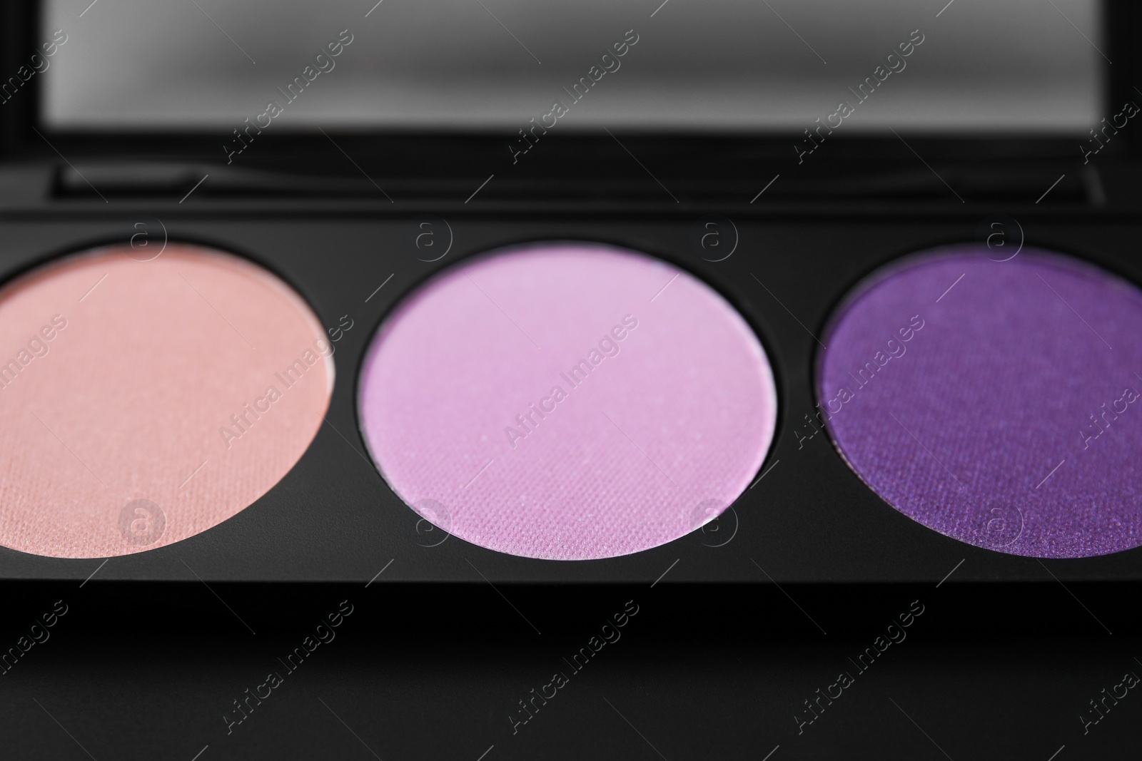 Photo of Beautiful eyeshadow palette as background, closeup. Professional cosmetic product