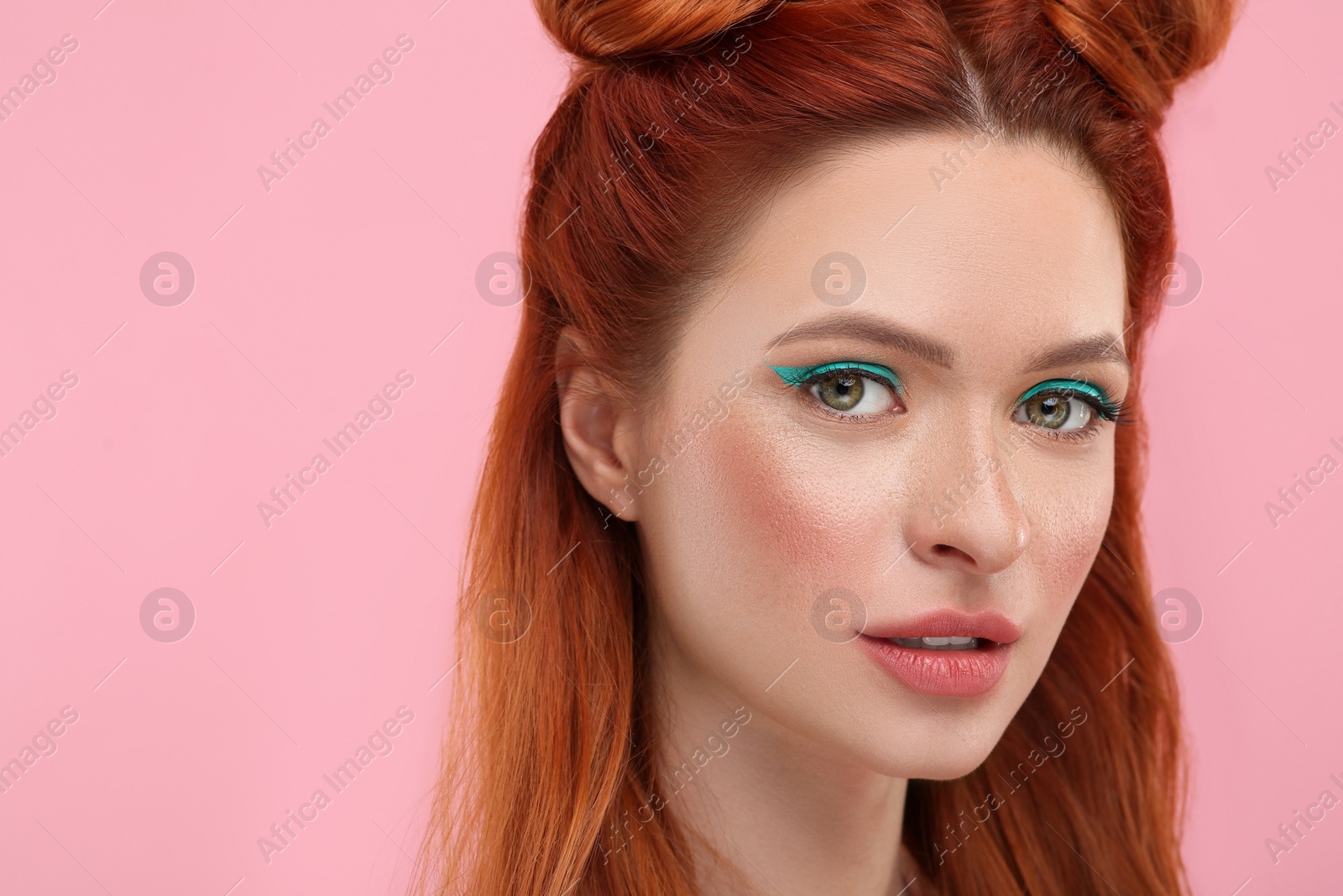 Photo of Portrait of beautiful woman with bright makeup on pink background. Space for text