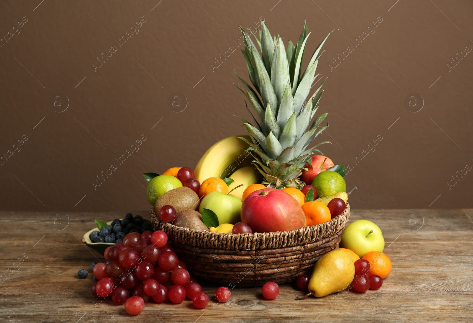 Photo of Assortment of fresh exotic fruits on wooden table