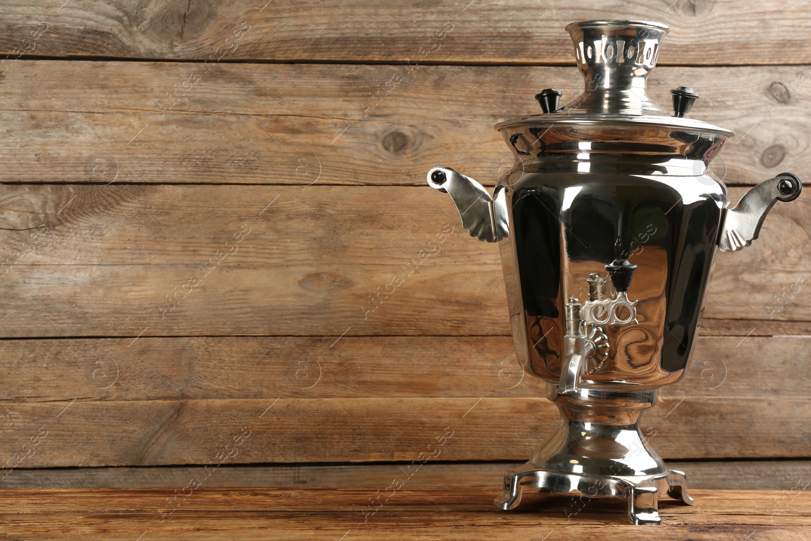 Photo of Traditional Russian samovar on wooden background. Space for text