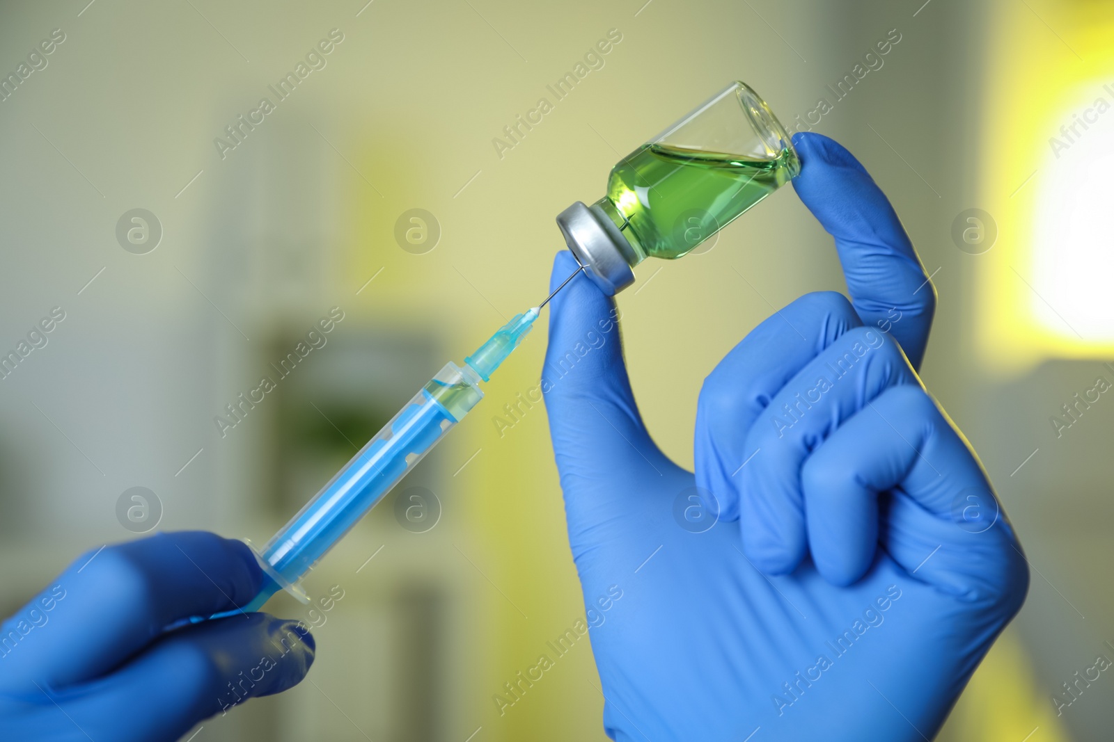 Photo of Doctor filling syringe with medication in clinic, closeup. Vaccination and immunization