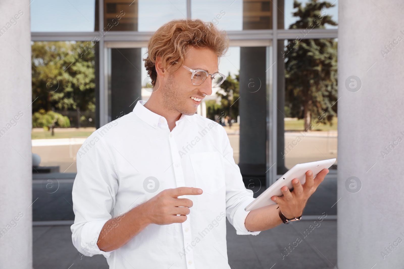 Photo of Male real estate agent with tablet outdoors