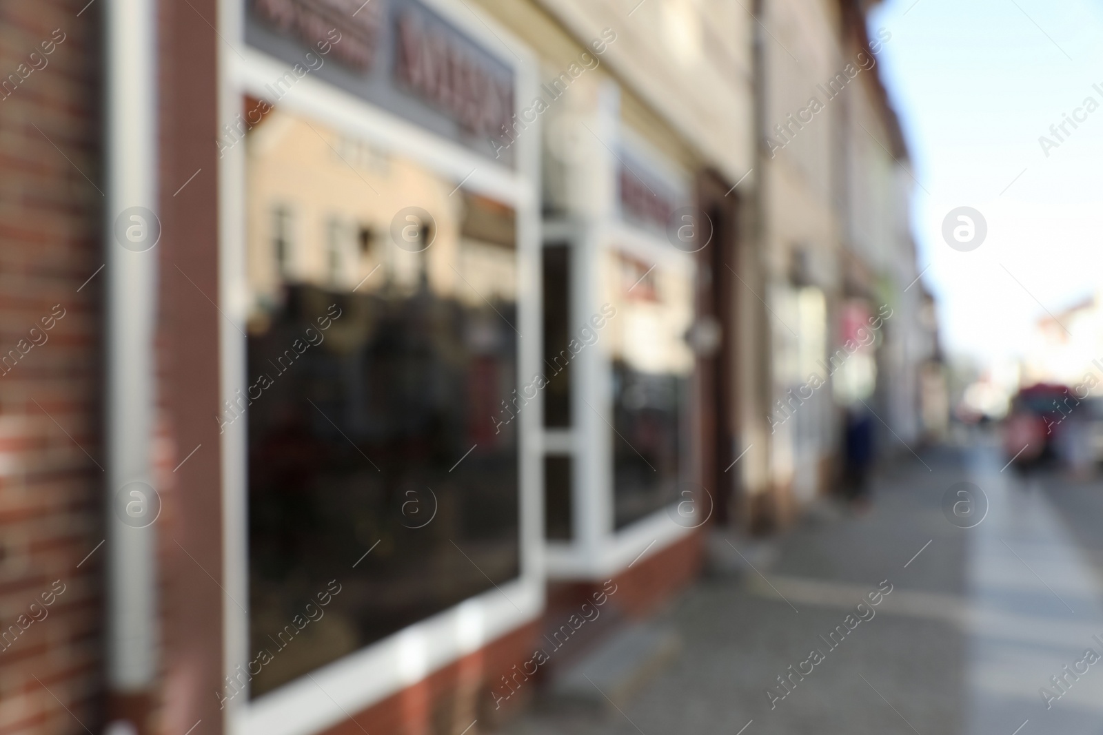 Photo of Blurred view of store exterior and city street. Bokeh effect