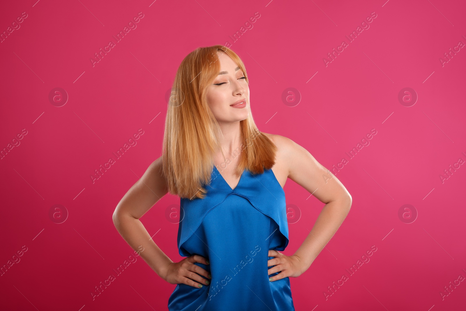 Photo of Beautiful young woman with blonde hair on pink background