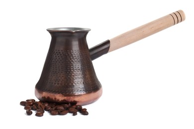 Photo of Metal turkish coffee pot and beans on white background