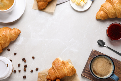 Photo of Flat lay composition with tasty croissants on light grey marble table, space for text