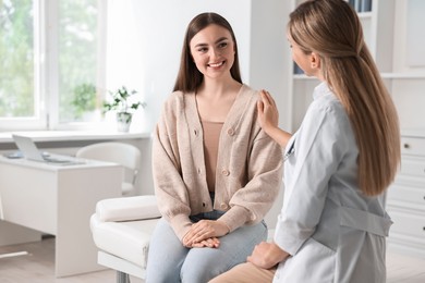 Photo of Professional doctor working with patient in hospital, space for text