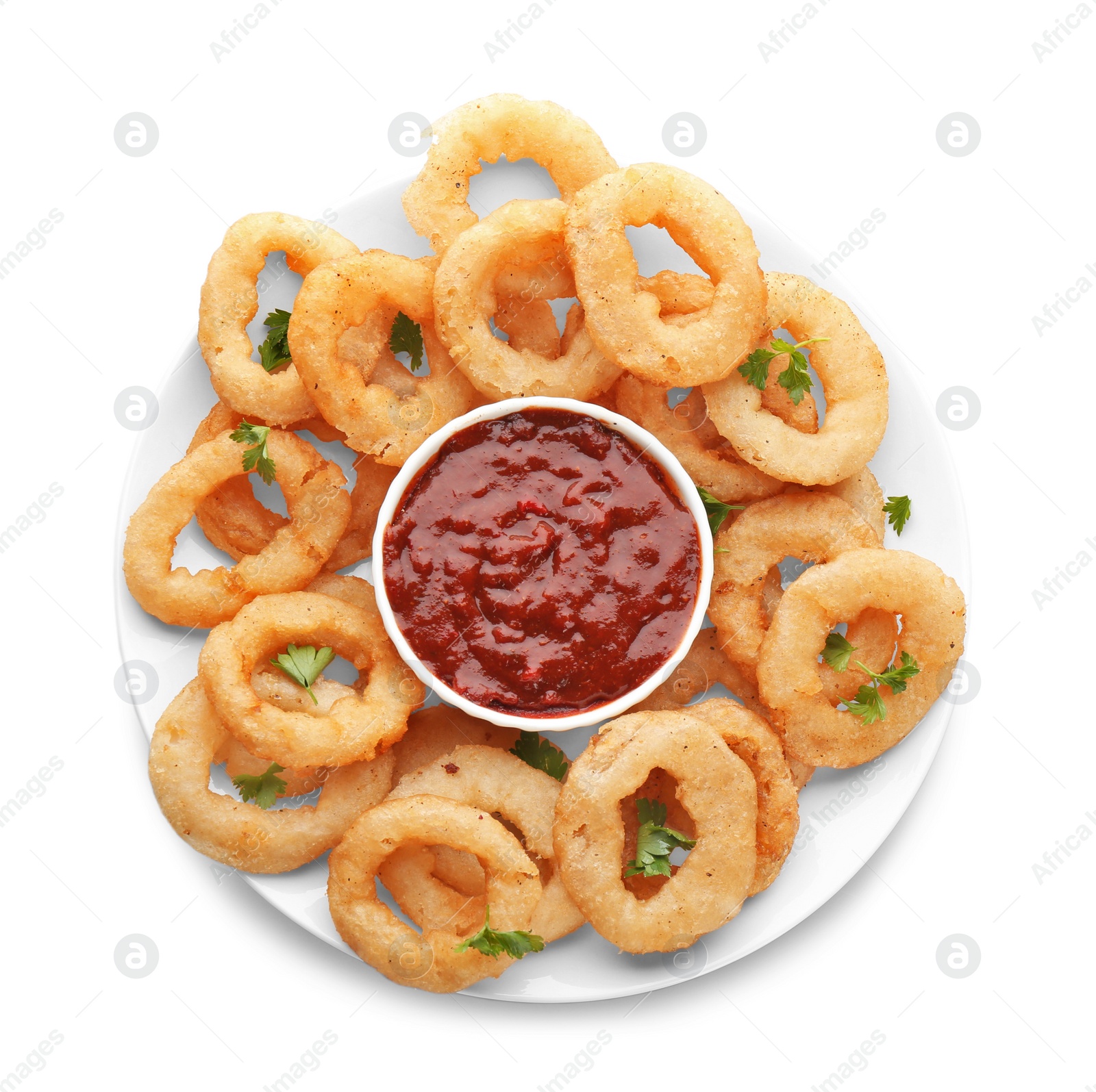 Photo of Plate with fried onion rings and bowl of sauce on white background, top view