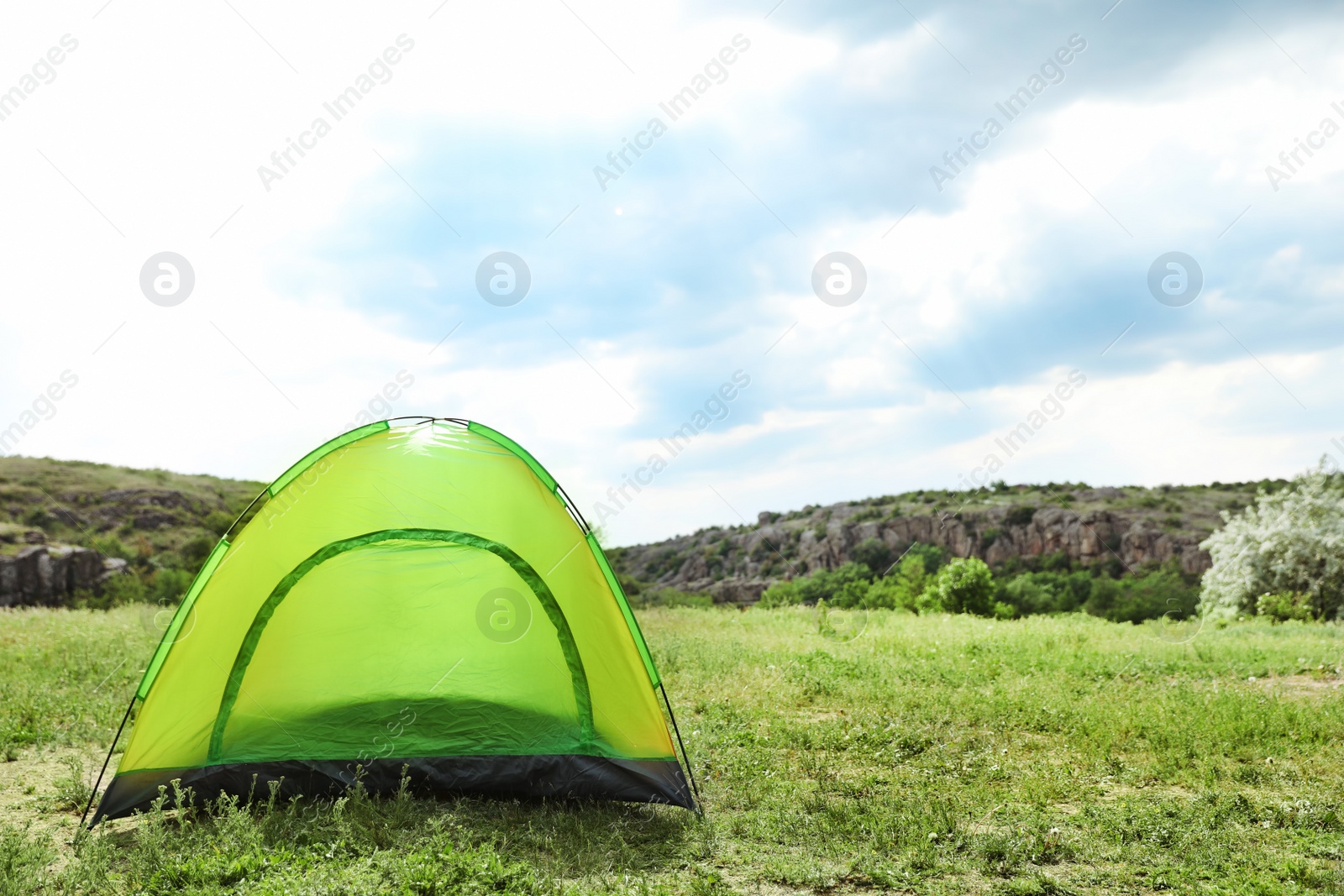 Photo of Small tourist tent in wilderness. Camping season