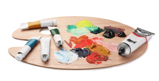 Photo of Wooden palette with oil paints on white background