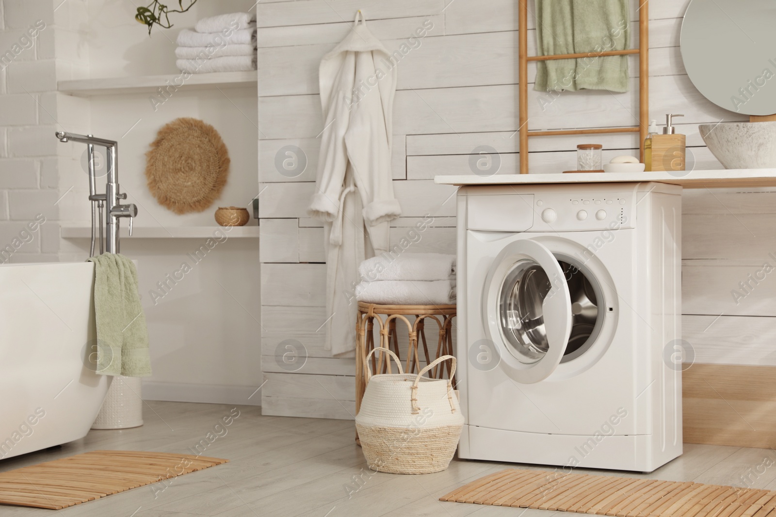 Photo of Stylish bathroom interior with modern washing machine