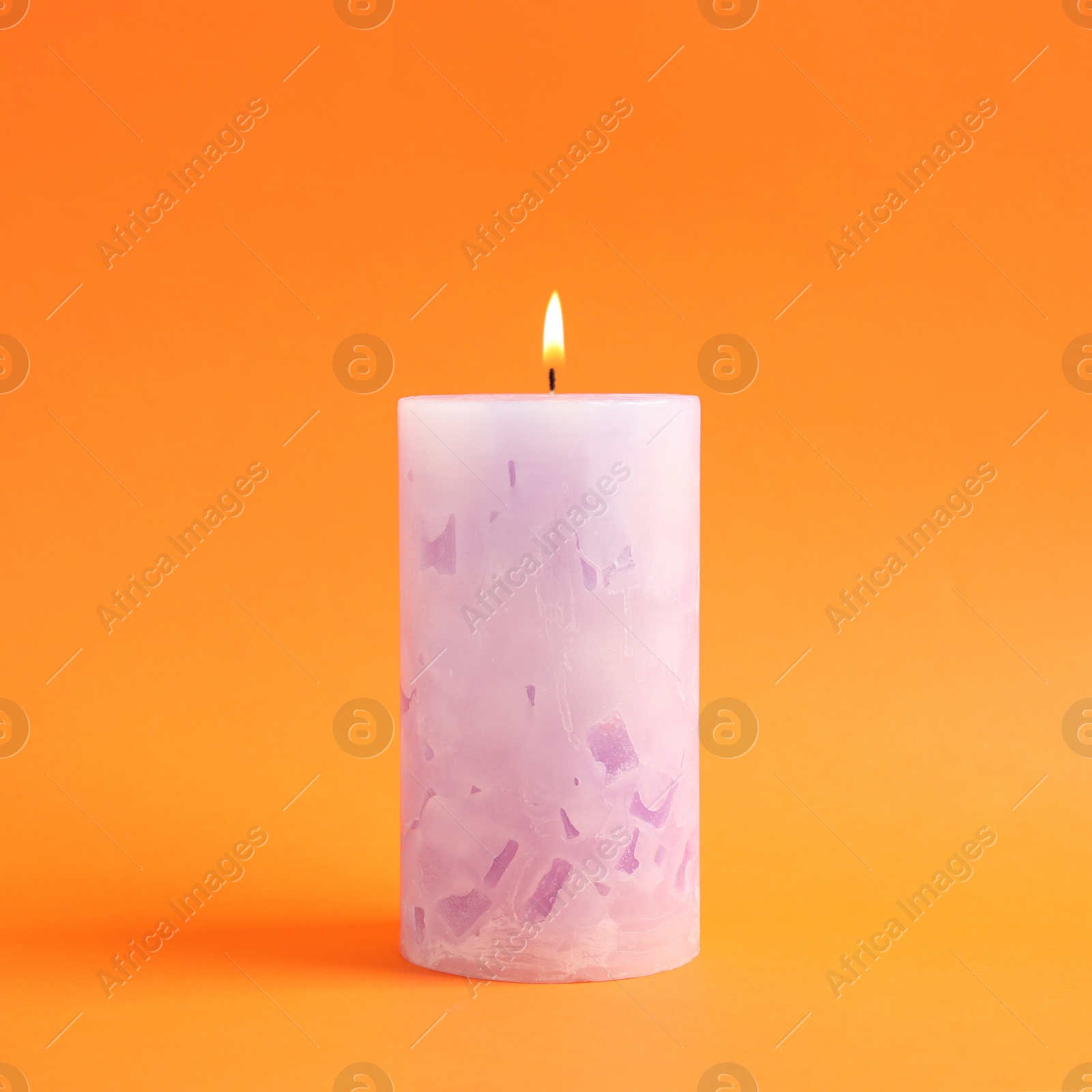 Photo of Alight scented wax candle on color background