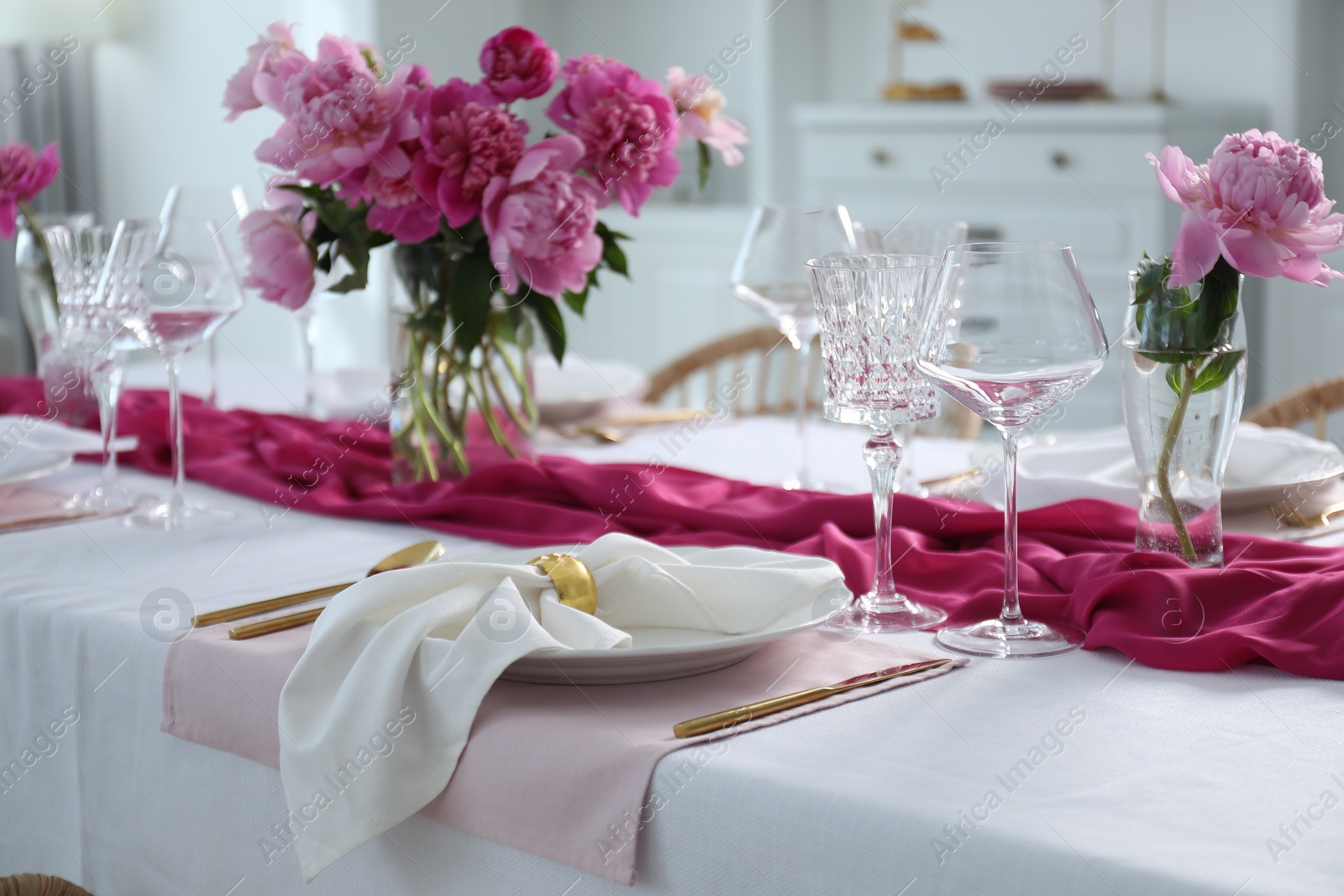 Photo of Beautiful table setting with pink peonies in dining room