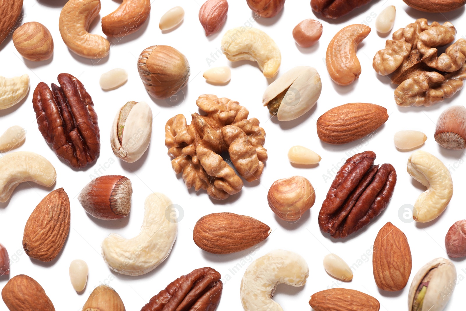 Photo of Different delicious nuts on white background, flat lay