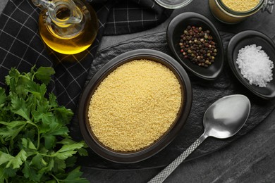Photo of Raw couscous and ingredients on grey table, flat lay