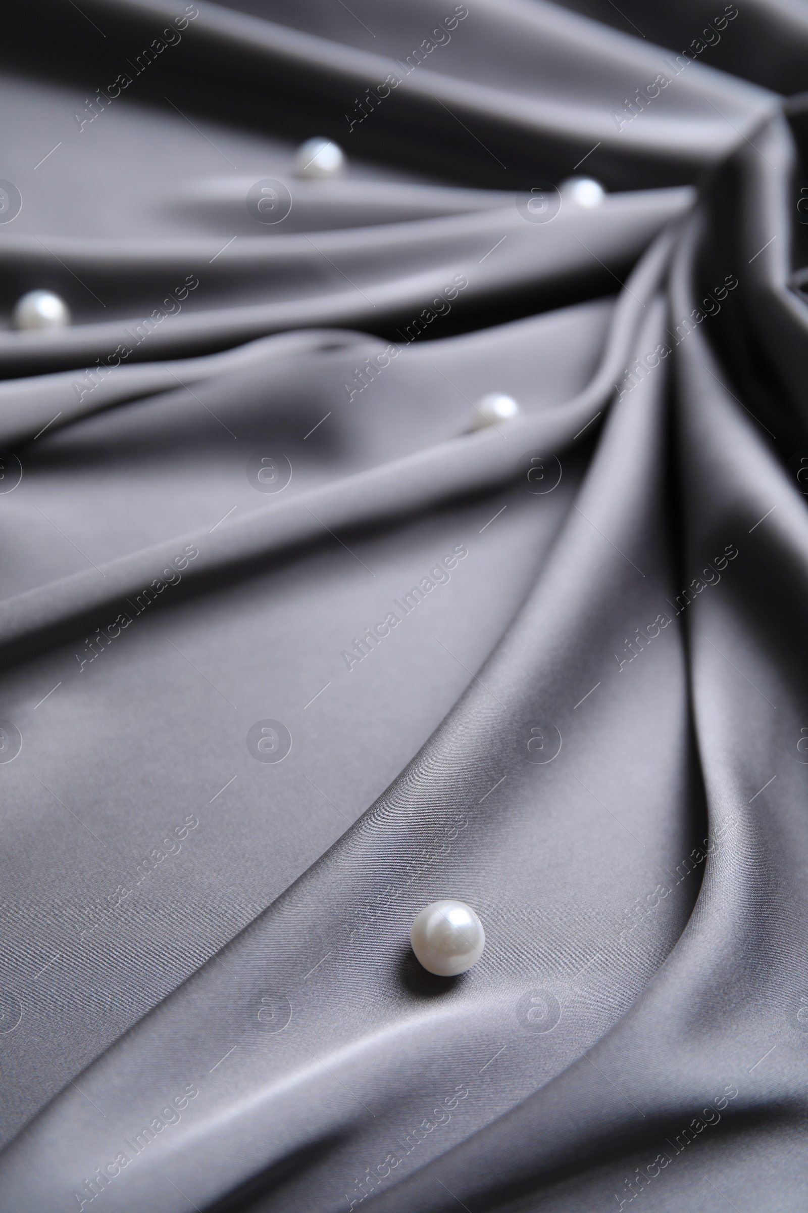 Photo of Many beautiful pearls on delicate black silk, closeup