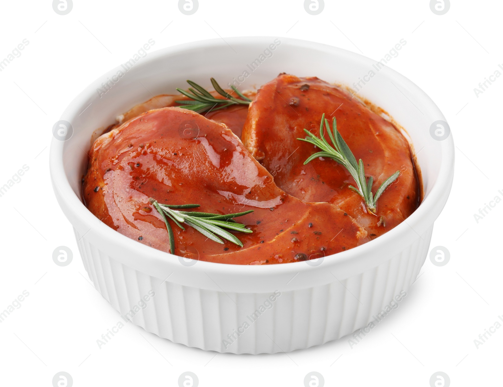 Photo of Raw marinated meat and rosemary in bowl isolated on white