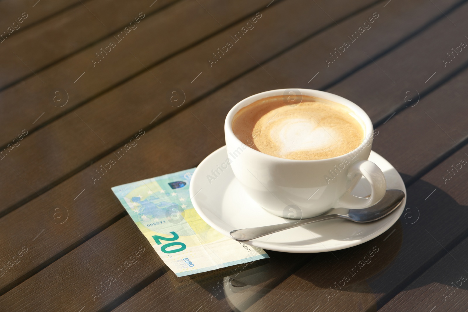 Photo of Tasty hot coffee and payment for order on table, space for text. Leave tip