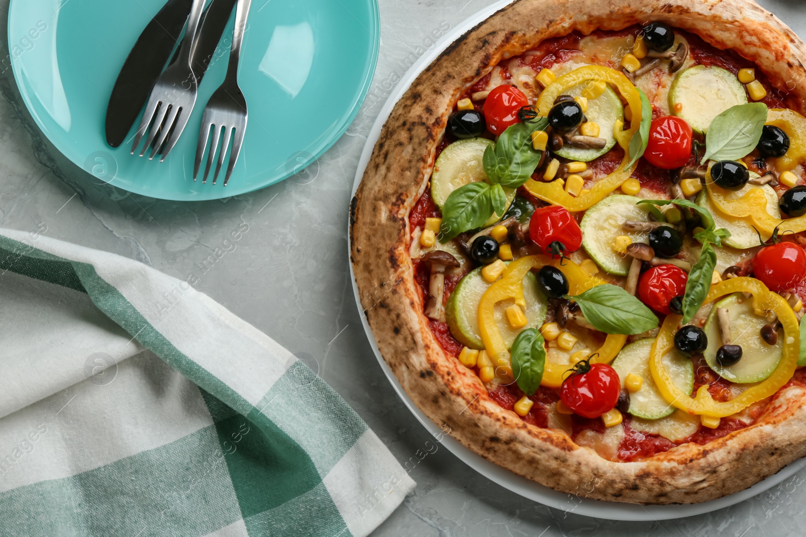 Photo of Tasty vegetable pizza on light grey table, flat lay