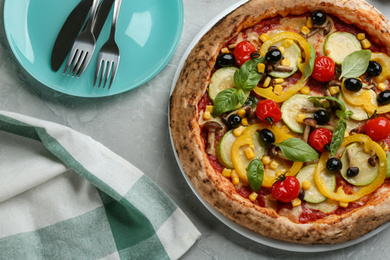 Tasty vegetable pizza on light grey table, flat lay