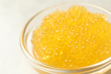 Photo of Fresh pike caviar in bowl on light grey table, closeup