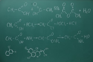 Chemical formulas written with chalk on green board