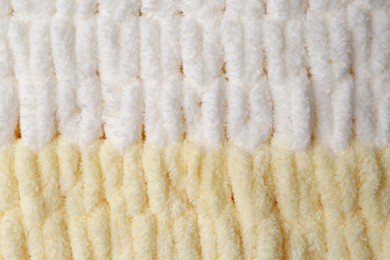 Soft knitted fabric as background, top view