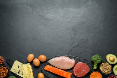 Photo of Different fresh products on black table, flat lay and space for text. Sources of essential amino acids