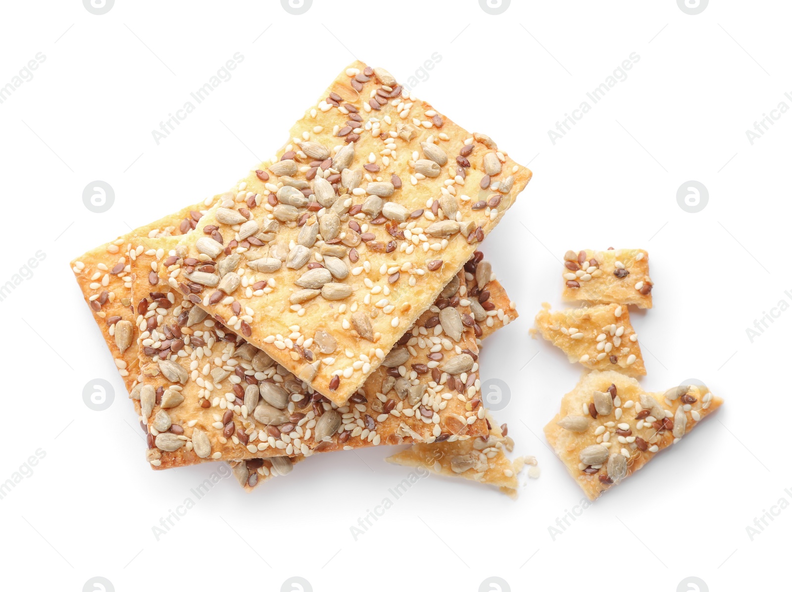 Photo of Broken crispy crackers with different seeds isolated on white