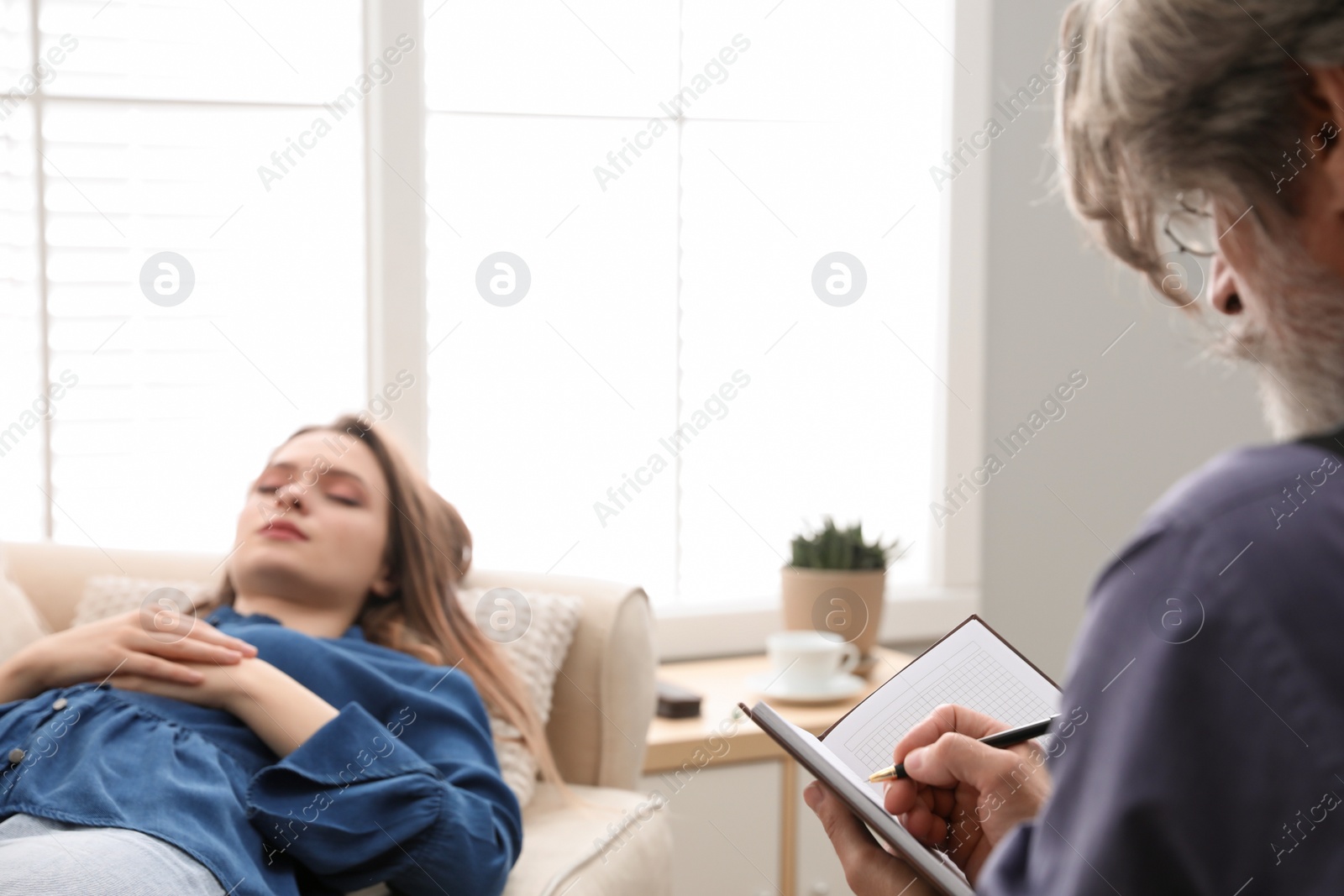 Photo of Psychotherapist and patient in office. Hypnotherapy session