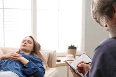 Photo of Psychotherapist and patient in office. Hypnotherapy session