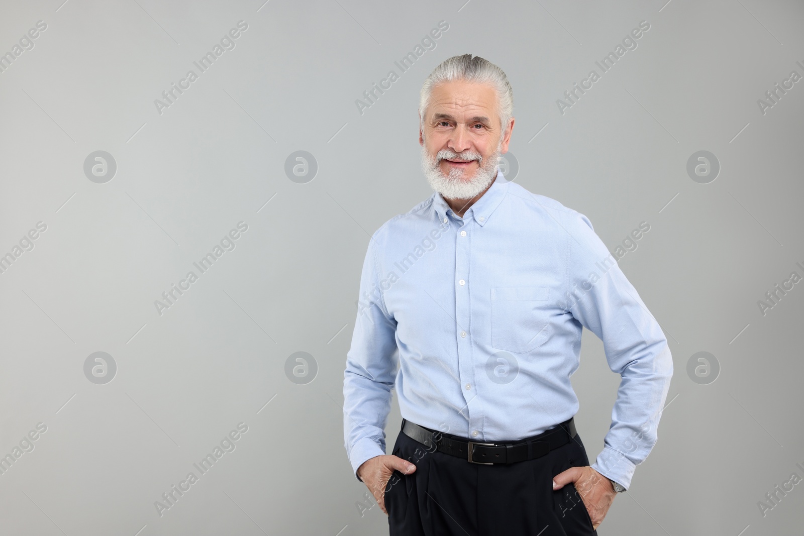 Photo of Portrait of handsome senior man on light grey background. Space for text