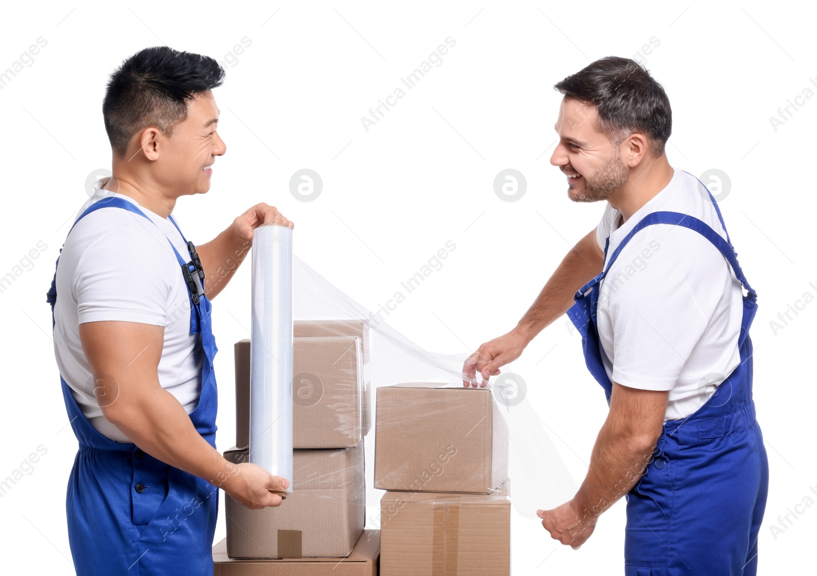 Photo of Workers wrapping boxes in stretch film on white background