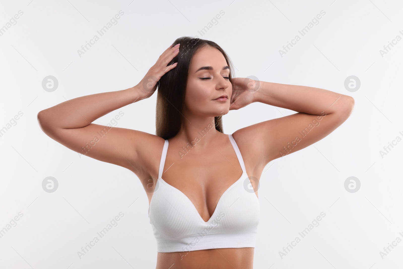 Photo of Portrait of young woman with beautiful breast on white background