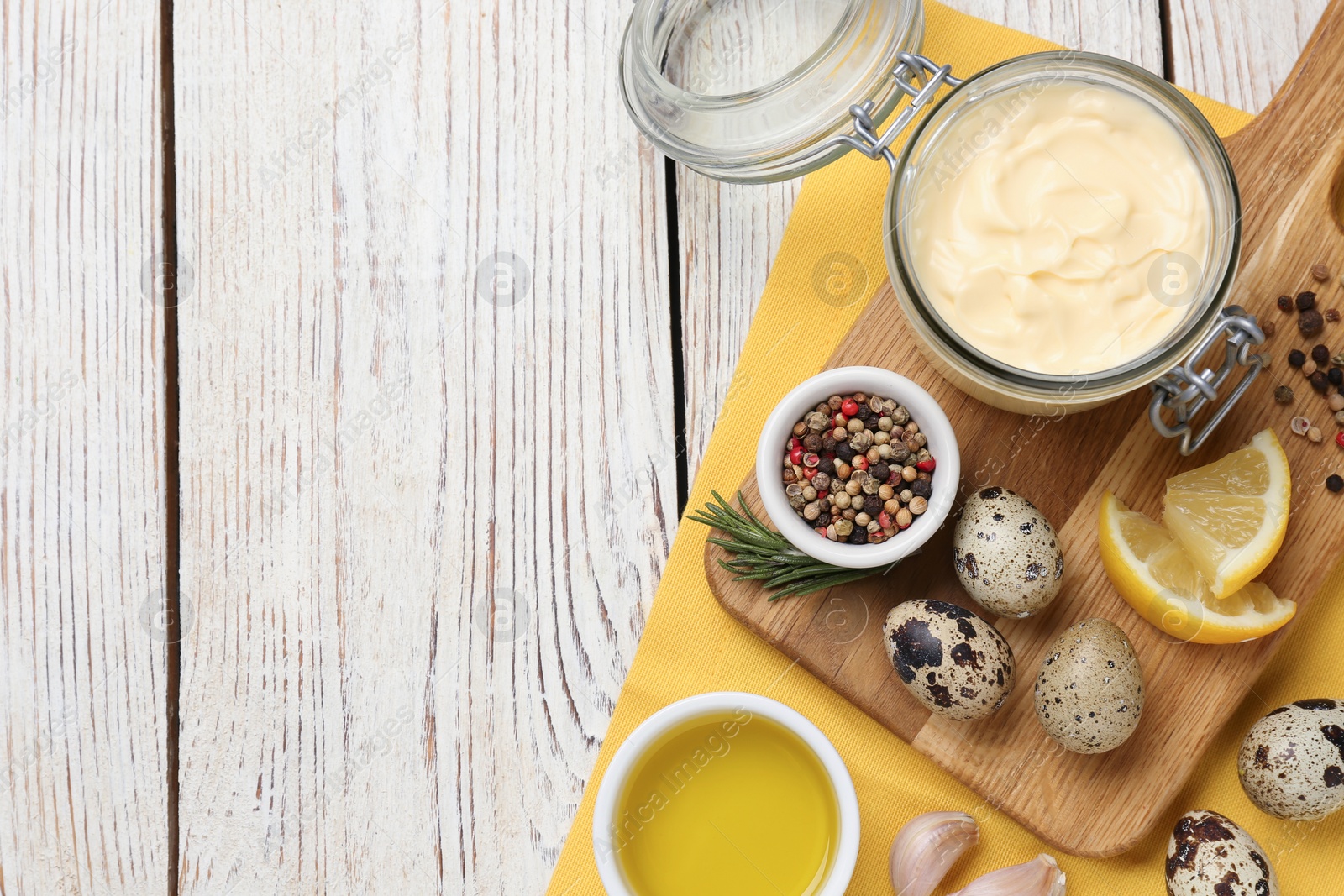 Photo of Delicious homemade mayonnaise, spices and ingredients on white wooden table, top view. Space for text