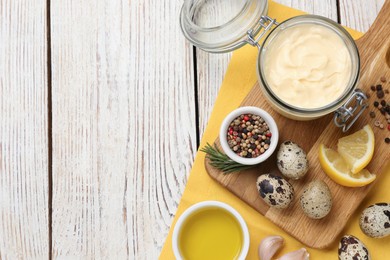 Delicious homemade mayonnaise, spices and ingredients on white wooden table, top view. Space for text