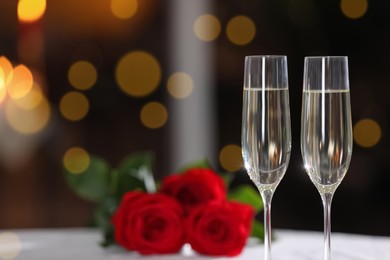 Photo of Glasses of champagne on table in restaurant, space for text. Romantic dinner