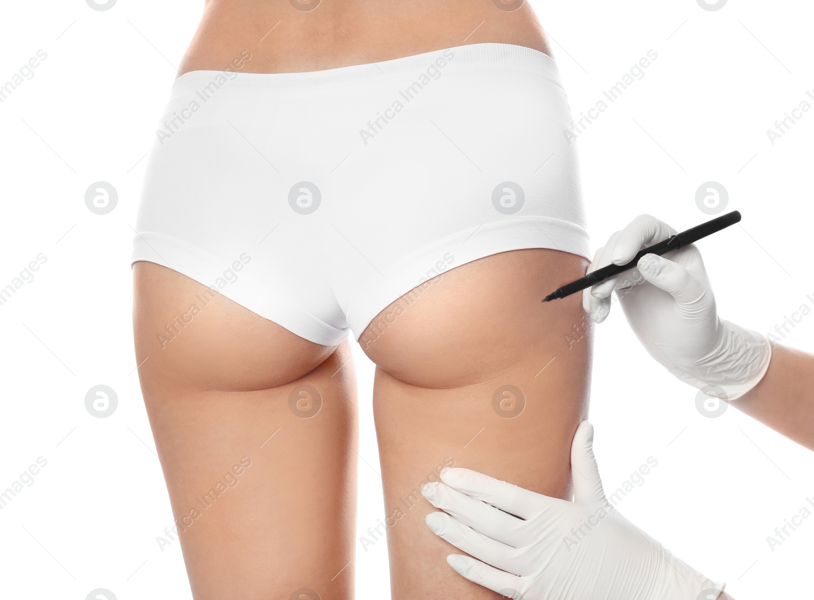 Photo of Doctor holding marker near young woman's buttock isolated on white, closeup. Plastic surgery concept