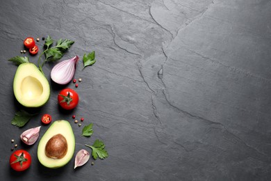 Fresh guacamole ingredients on black table, flat lay. Space for text