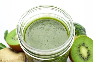 Delicious fresh green juice in glass on white background, closeup