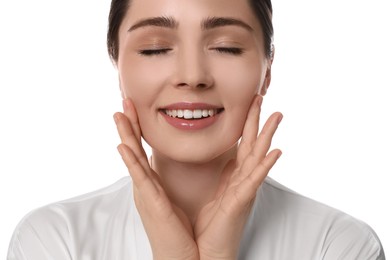 Young woman massaging her face on white background